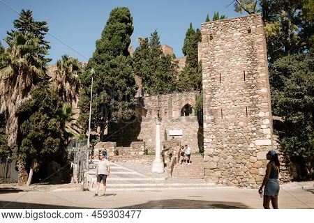 Malaga, Spain; July 31, 2021: People In The Square And Entrance Of The Alcazaba Of Malaga, Next To T