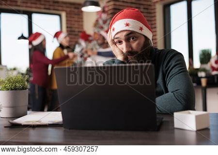 Tired Distrubed Man Trying To Work In Office, Feeling Frustrated And Overwhelmed Because Of Noisy Co