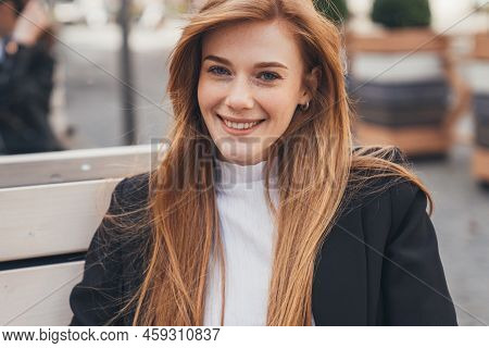 Businesswoman Portrait With Long Foxy Hair And Freckled Face Looking At Smiling At Camera, Sitting O