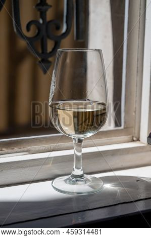 Tasting Of White Grand Cru Classe Chablis Wine With Old French Houses On Background, Burgundy, Franc