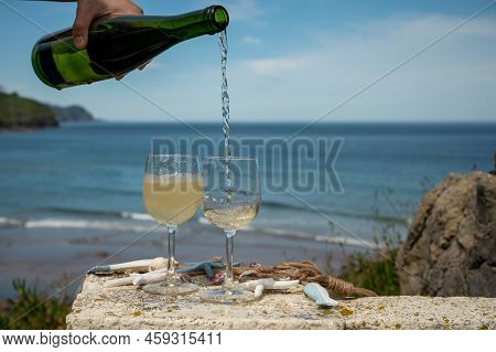 Pouring Of Txakoli Or Chacolí Slightly Sparkling Very Dry White Wine Produced In The Spanish Basque