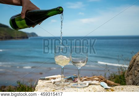 Pouring Of Txakoli Or Chacolí Slightly Sparkling Very Dry White Wine Produced In The Spanish Basque