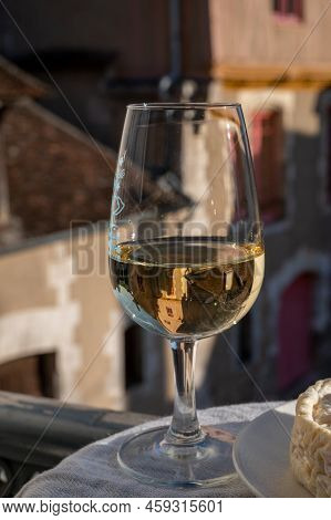 Tasting Of White Grand Cru Classe Chablis Wine With Old French Houses On Background, Burgundy, Franc