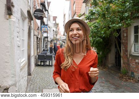 Smiling Tourist Woman Strolling In Schnoor Neighborhood, Bremen, Germany