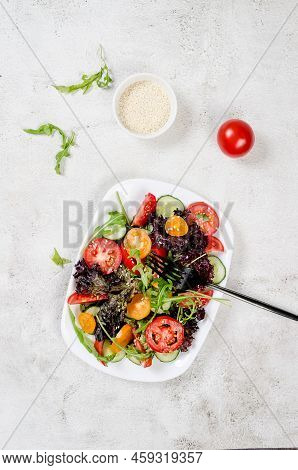 Healthy Vegetable Salad With Fresh Salad Leaves, Arugula, Cherry Tomato, Cucomber And Parsley In Pla