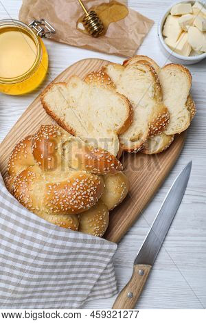 Cut Freshly Baked Braided Bread, Honey And Butter On White Wooden Table, Flat Lay. Traditional Shabb