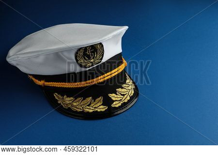 Peaked Cap With Accessories On Blue Background, Space For Text