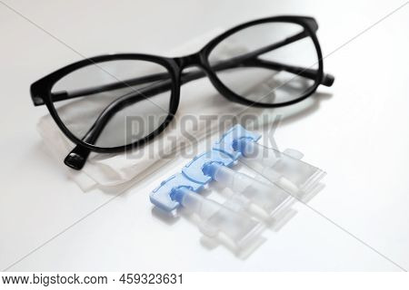 Single Dose Eye Drops, Glasses And Fabric On White Table