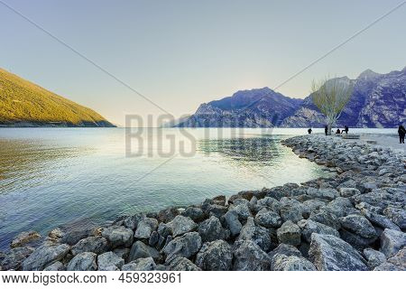 Nago-torbole, Italy - February 26, 2022: View Of The North Shore Of Lake Garda, With Locals And Visi