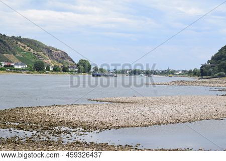 Dry Arts Of The Rhine With A Cargo Ship Passing It