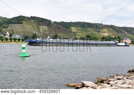 Namedy, Germany - 08 01 2022: Cargo Ship On The Rhine, Close To The Shore In Dry Summer
