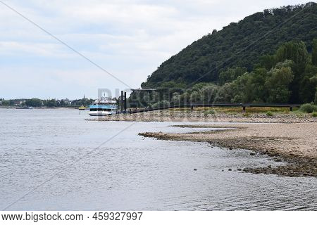 Namedy, Germany - 08 01 2022: Low Water Level Of The Rhine With A Passenger Ship Still Operating