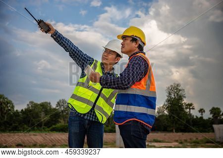 Engineer And Foreman Worker Checking Project At Building Site, Engineer And Builders In Hardhats Dis