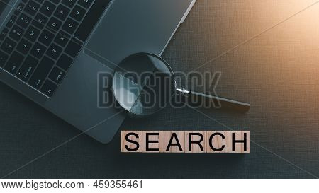 A Magnifying Glass Is Placed On A Notebook Computer, The Concept Of Searching For Information In The