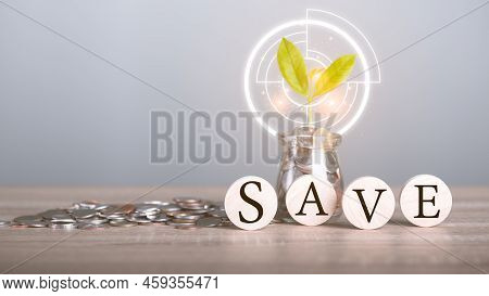 Glass Jars, Wooden Blocks And Stacks Of Coins, All On A Wooden Table, Financial And Banking, Fund Gr