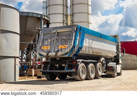 Large Dump Truck Near The Concrete Factory. Car Tonar For Transportation Of Heavy Bulk Cargo. Provis
