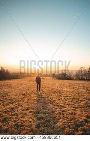 Young Ambitious Tourist Walks Through The Grain Fields At Sunset In The Beskydy Mountains, Czech Rep