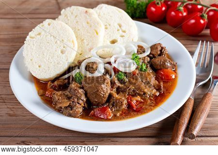 Traditional Czech Goulash With Dumplings On Wooden Table