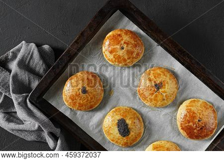 Traditional Christmas Austrian Pies Mohnzelten On Cooking Paper On Dark Background, Top View