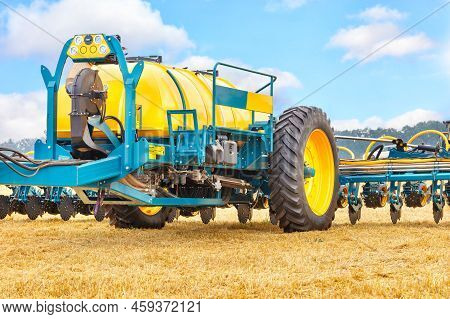 A Fragment Of A Multi-row Agricultural Seeder In The Form Of A Trailed Large Container And Multi-row