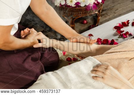 Asian Woman Enjoying A Salt Scrub Massage At Spa. Healthcare Spa And Massage Thai Concept  Girl Rece