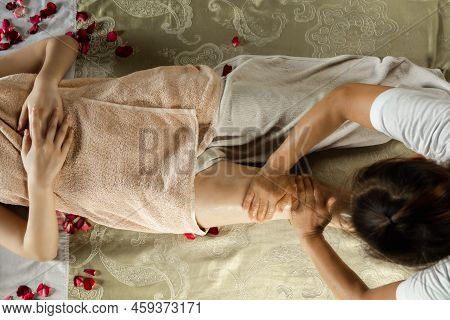 Asian Woman Enjoying A Salt Scrub Massage At Spa. Healthcare Spa And Massage Thai Concept  Girl Rece