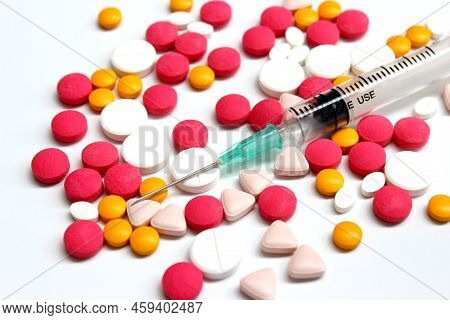 Several Kinds Of Drug Tablet And 3 Ml Syringe Isolated On The White Background