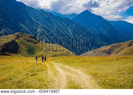 Men Walk Along The Road High In The Mountains, The Village Of Galiat, North Ossetia.