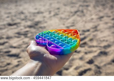 Colorful Antistress Sensory Toy. Pop It Kids Game In Hand. Outdoor Games For Children. Bright Multi-