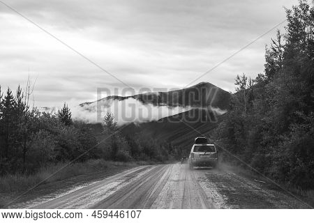 Polebridge, Montana - July 3, 2022: Dusty, Muddy Wet Dirt Road Leading To Polebridge Montana From Gl