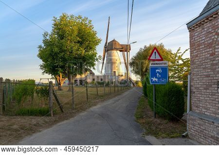 Early In The Morning There Is A Beautiful Windmill Whit The Sun Rising In The Sky