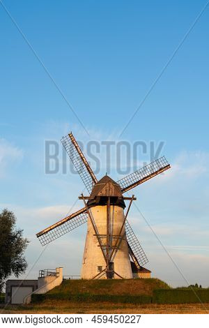 Early In The Morning There Is A Beautiful Windmill Whit The Sun Rising In The Sky