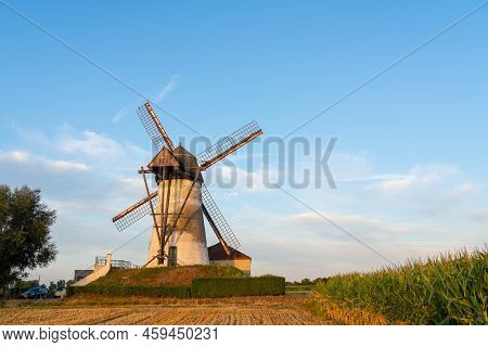 Early In The Morning There Is A Beautiful Windmill Whit The Sun Rising In The Sky