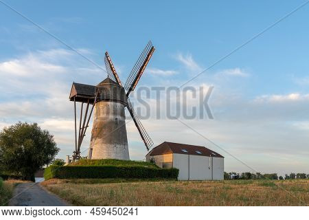 Early In The Morning There Is A Beautiful Windmill Whit The Sun Rising In The Sky