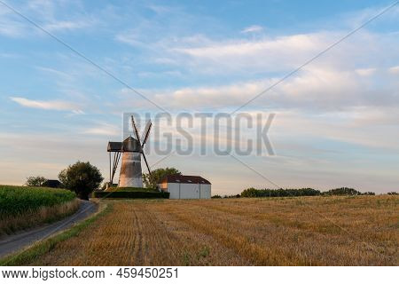 Early In The Morning There Is A Beautiful Windmill Whit The Sun Rising In The Sky