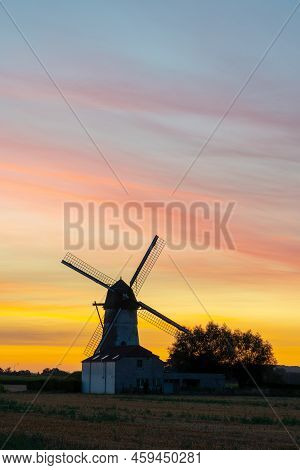 Early In The Morning There Is A Beautiful Windmill Whit The Sun Rising In The Sky