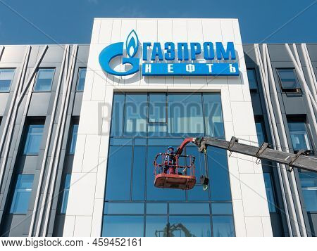 Noyabrsk, Russia - May 28, 2022: Man In Overalls Stands In A Lifting Bucket And Is About To Wash The