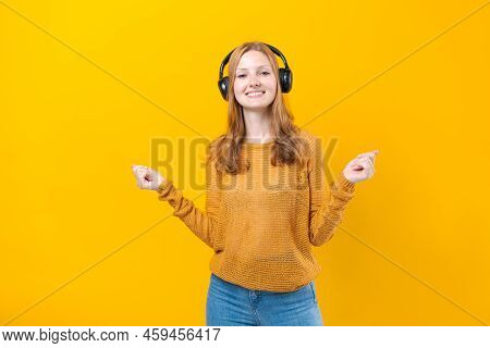 Woman Dancing To Music While Listening To Mp3 Player With Wired Headphones. Energy Move Of Caucasian