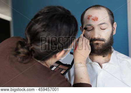 Artist Using Makeup Effects To Create Zombie Costume And Scary Dramatic Corpse Look. Man Looking Dec