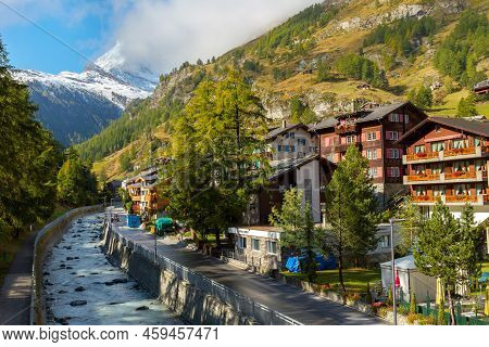 Zermatt, Switzerland - October 7, 2019: Town Street View In Famous Swiss Alps Ski Resort, River, Mat