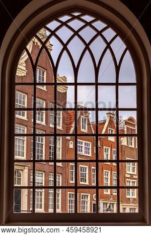 View Through The Window Of A Church At The Inner Court Of The Begijnhof In Amsterdam, The Netherland