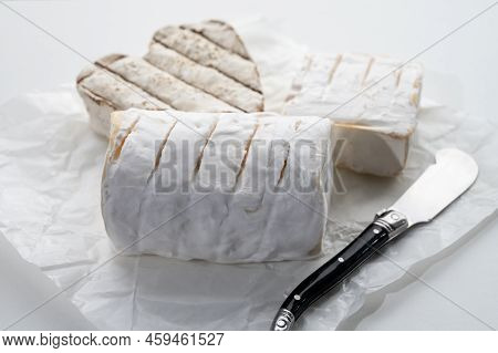French Cheeses Heartshaped, Squared And Cylindrical Neufchatel Cow Cheese With Mold On White Paper,