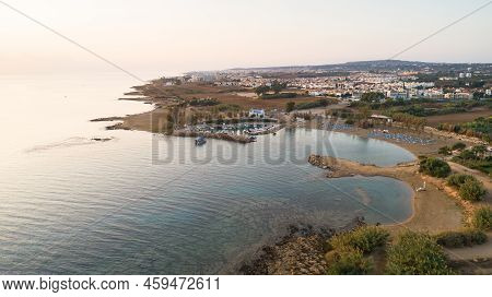 Aerial View Of Coastline Sunset And Landmark White Washed Chapel At Agia Triada Beach, Protaras, Fam