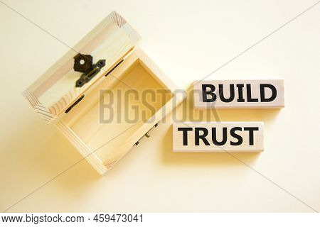 Build Trust Symbol. Concept Words Build Trust On Wooden Blocks On A Beautiful White Table White Back
