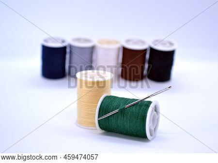 Threads And Needle. In The Photo, Colored Threads And A Needle.