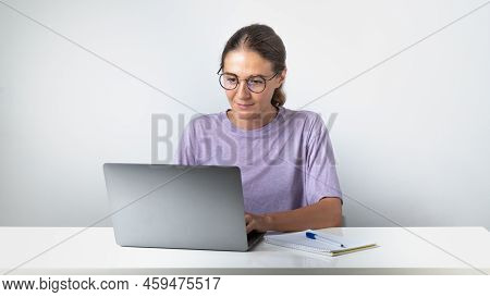 A Girl Typing At A Laptop - Remote Education And Work, Online Communication. High Quality Photo