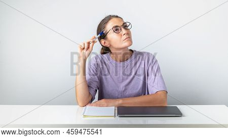 A Girl Student With A Laptop And A Notebook Thought About It. High Quality Photo