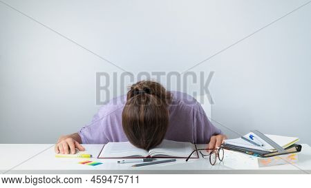 A Student Sleeps On A Textbook - Difficult Study, Heavy Load. High Quality Photo