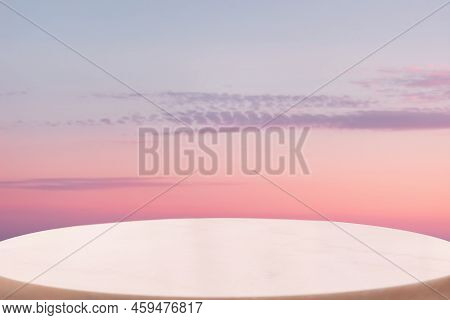 A White Marble Oval Pedestal Or Table Surface On A Pink Twillight Sky Background. Copy Space. The Co