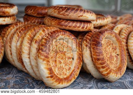 Typical Traditional Flatbread With Crunchy Crust With Sesam Just Baked In Tandoor On Market Display 